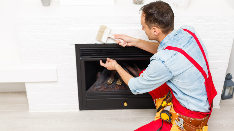 Man tending a fireplace