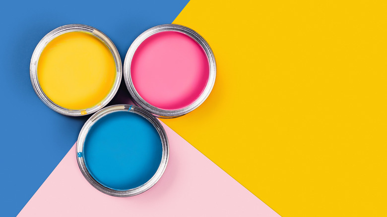 Three cans of colorful paint 
