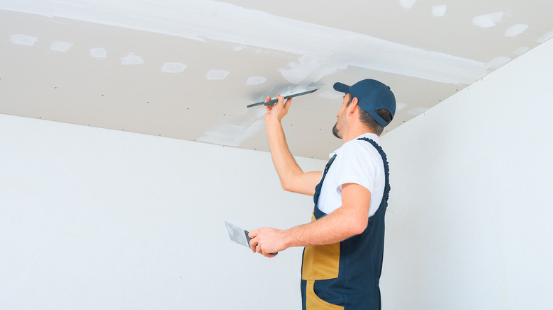 contractor smoothing a ceiling