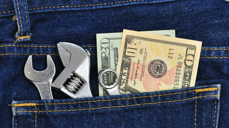 tools and cash in jean pocket