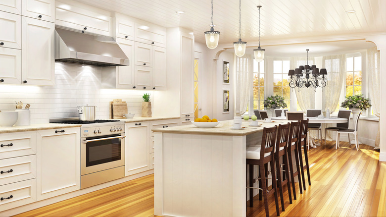 white kitchen with light wood floors