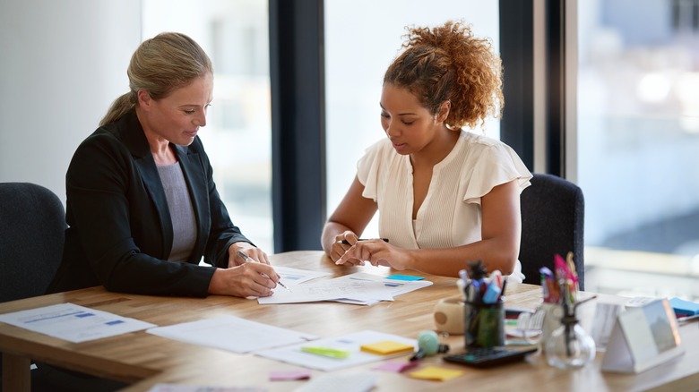 client and worker talking and taking notes.