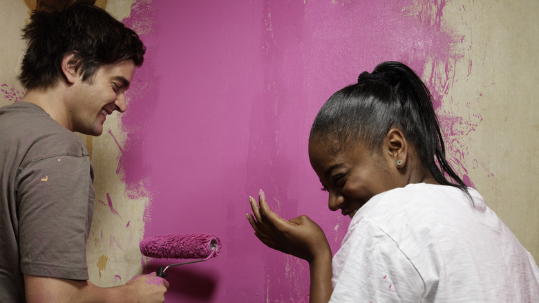 couple painting wall