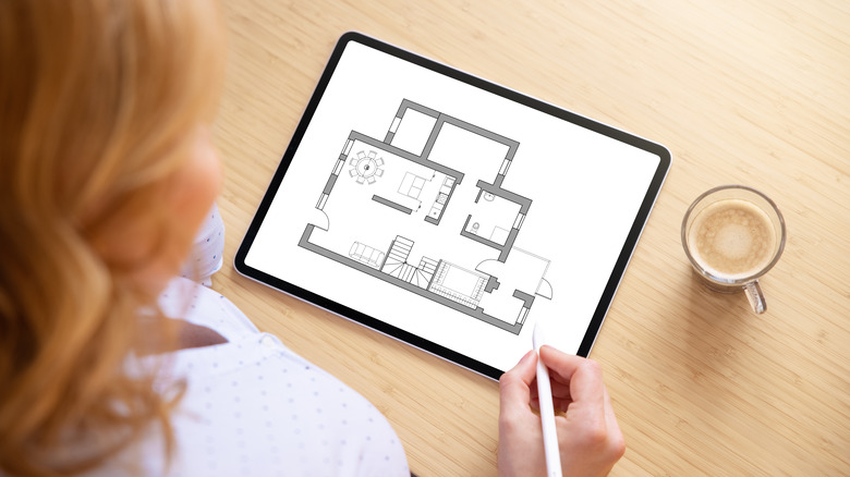 woman editing floor plan