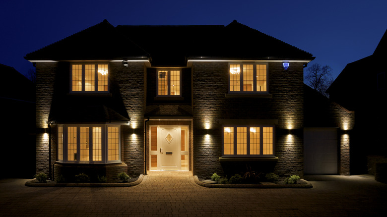 Exterior of a house with brightly-lit windows