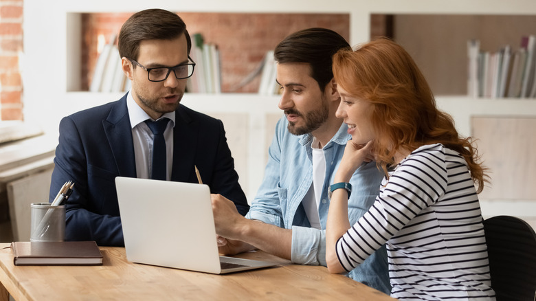 Couple talking with agent