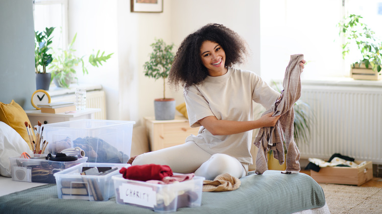 Woman decluttering a room