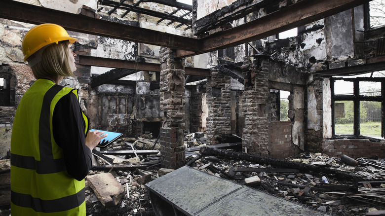 Woman assessing fire damage in home