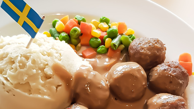 plate with veggies, meatballs, mashed potatoes and Swedish flag