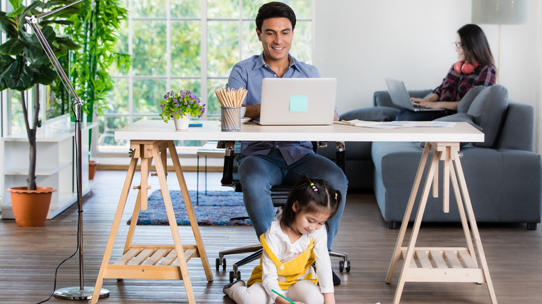 kid playing while dad's working