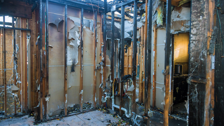 Fire damage has burned through the walls of a house