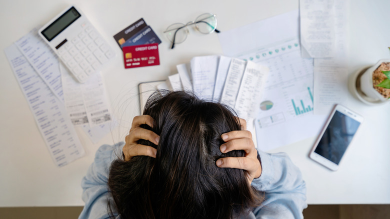 woman looking at bills and credit cards