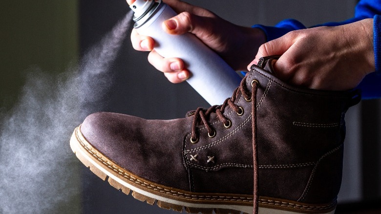 Spraying a suede boot with aerosol