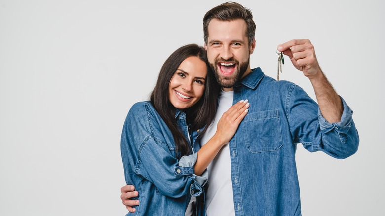 Smiling couple holding house keys