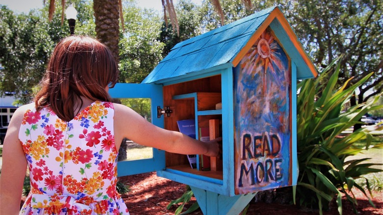 woman at Little Free Library