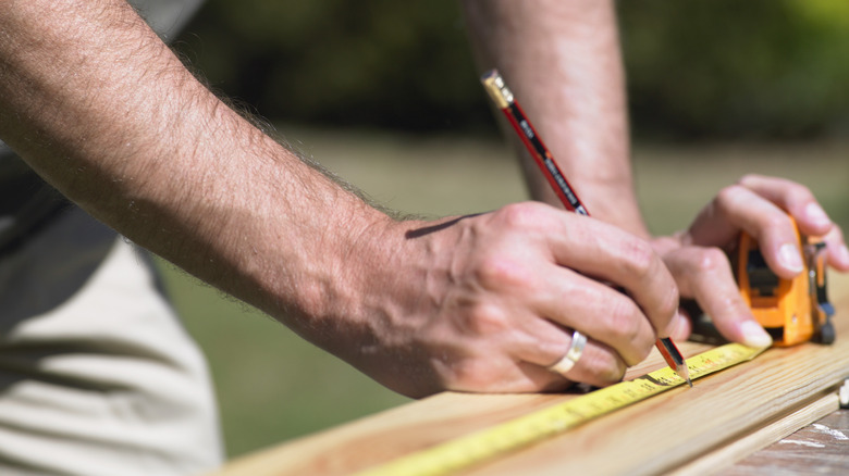 Closeup of person using measuring tape