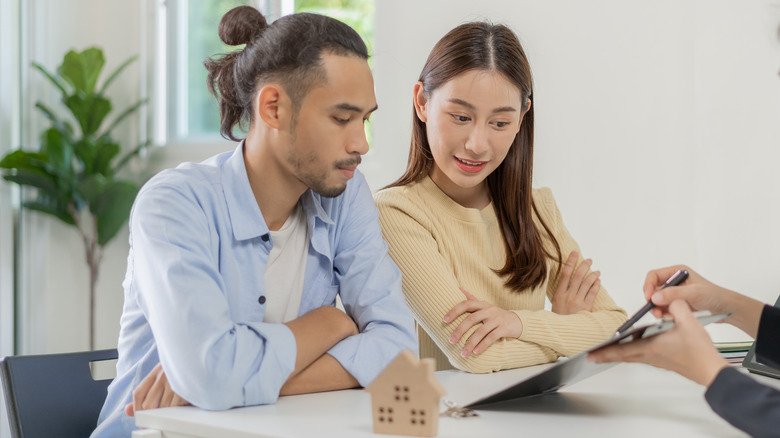 couple looking at mortgage contract