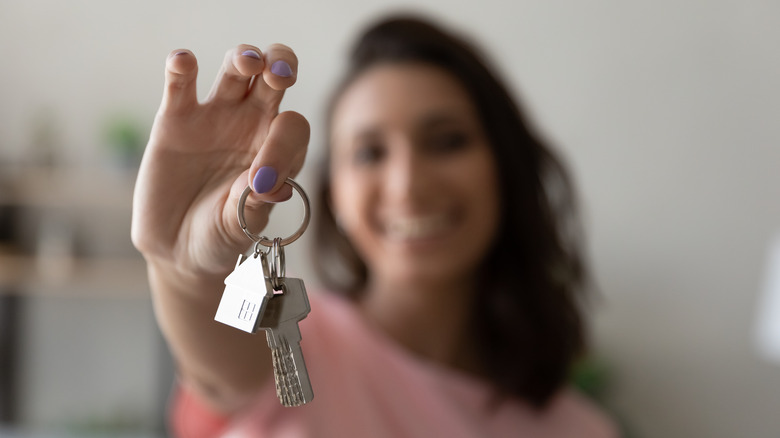 woman holding new house keys