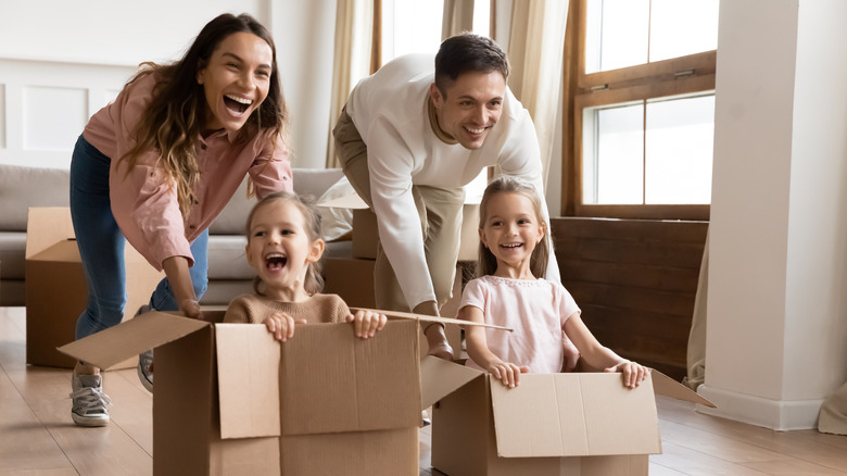 family playing with moving boxes