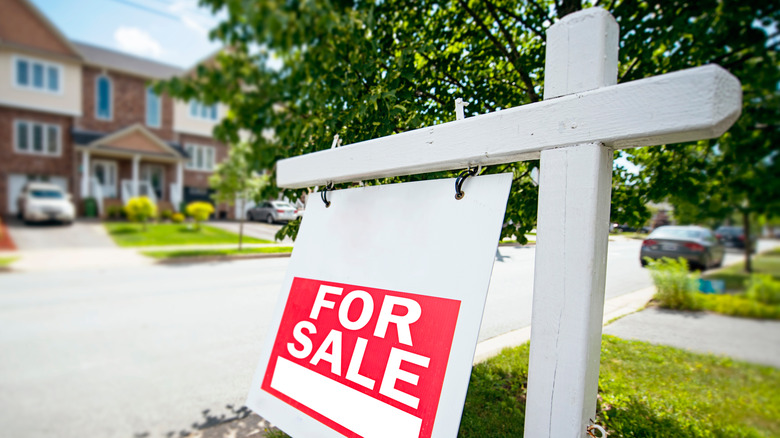 for sale sign near a home