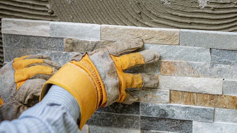 hands on stone tile