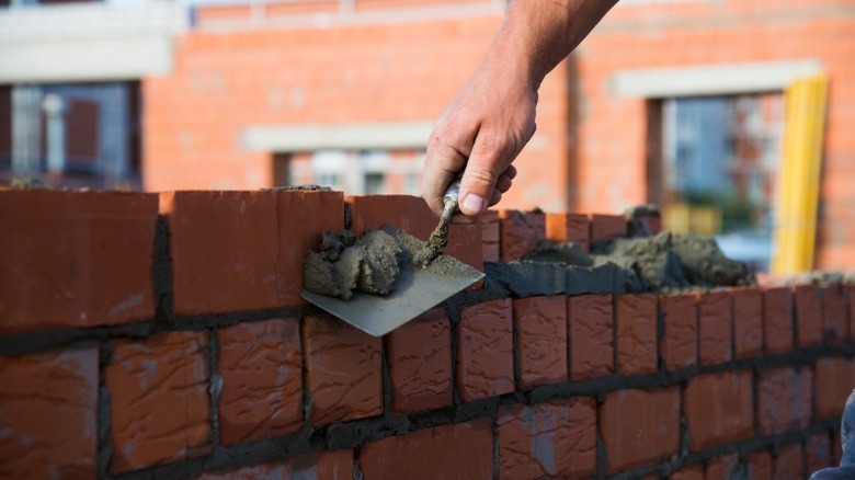 Man laying brick wall