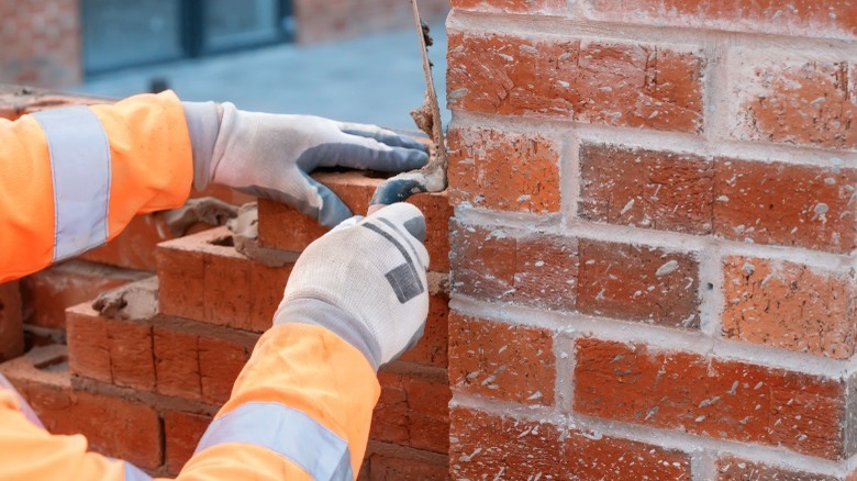 Person laying brick wall