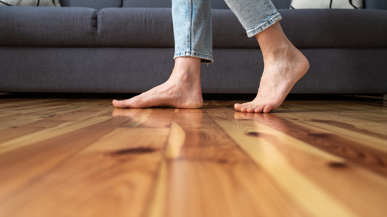 person walking on wood floor