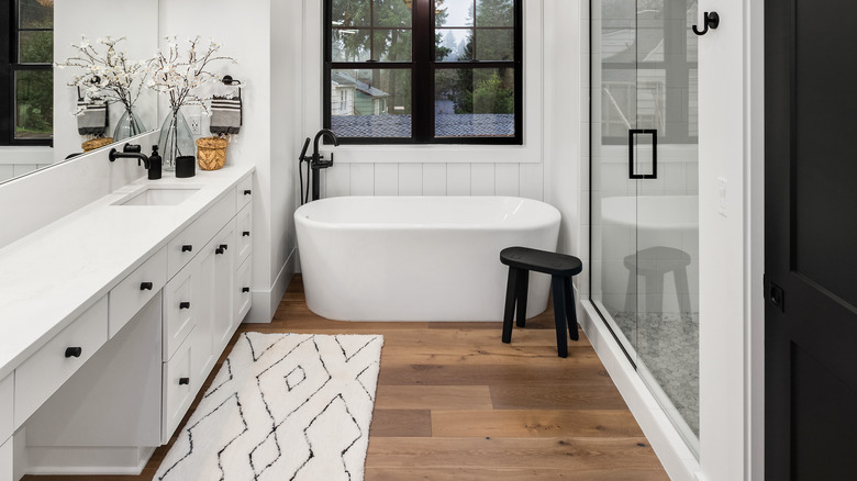 white bathroom with wood floors