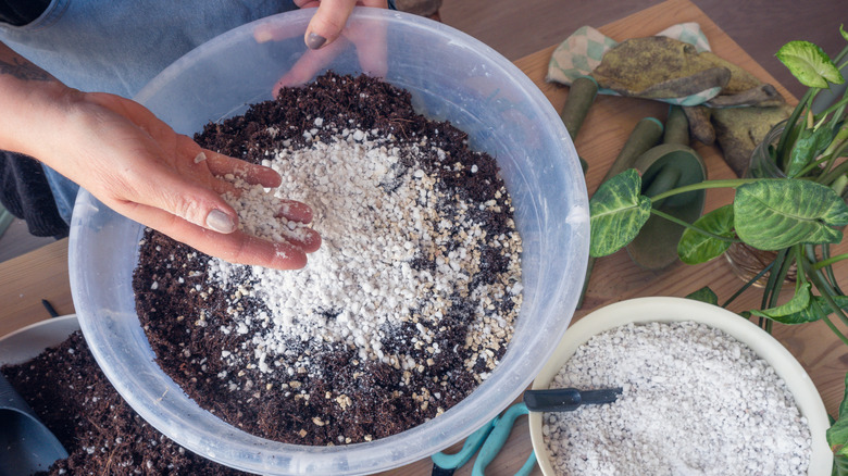 Person mixing homemade potting mix