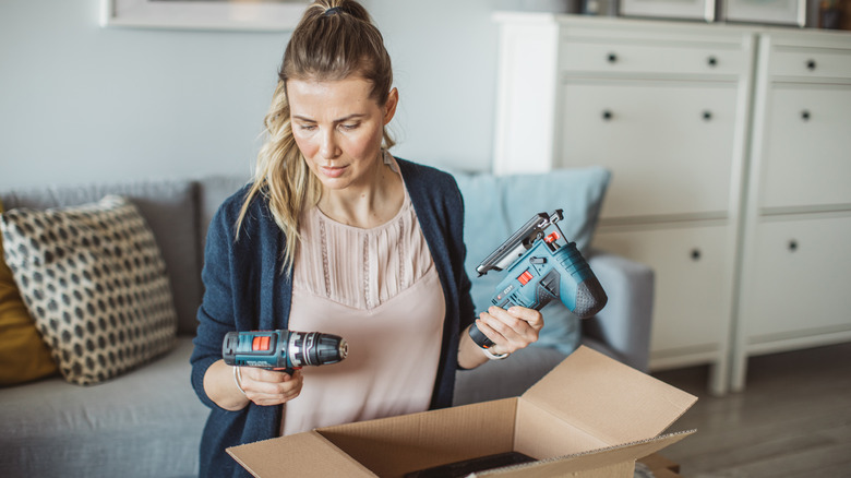 Woman holding power tools 