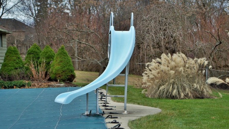 Pool slide on unused pool wintertime 