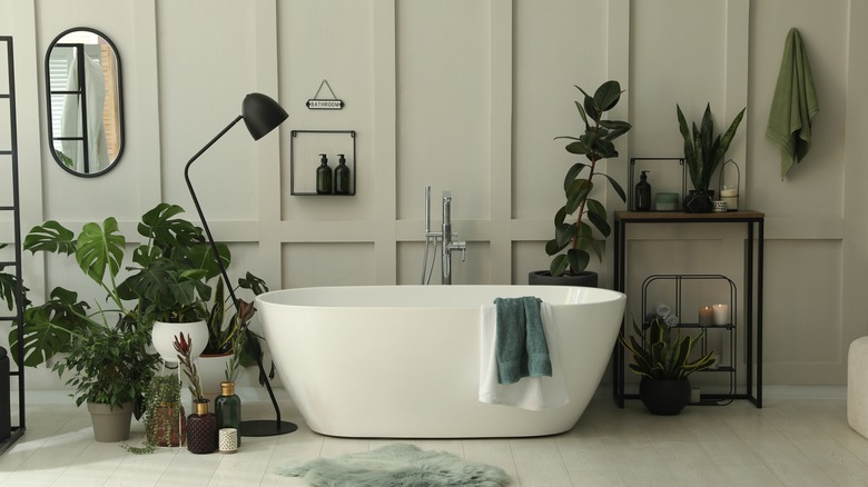 modern bathtub surrounded by greenery