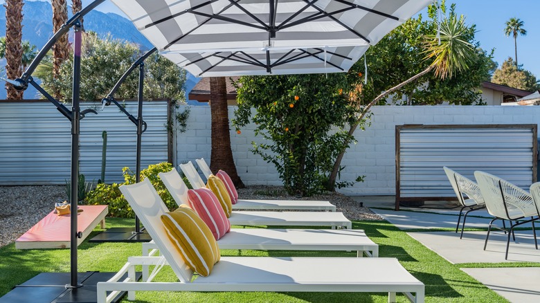 Cantilever umbrellas with recliners