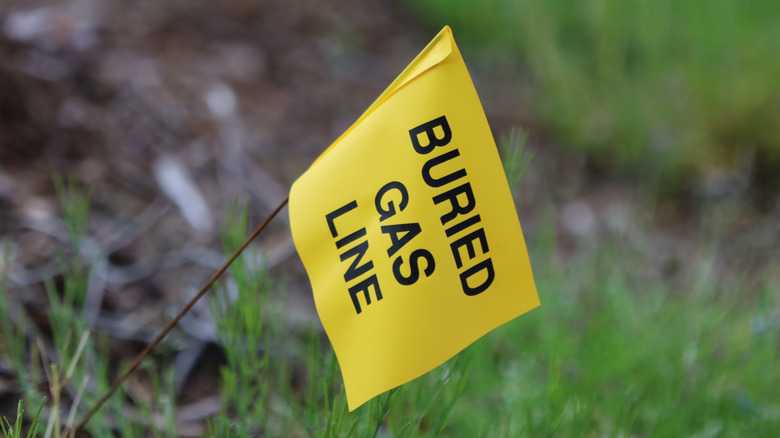 Yellow tag indicating buried gas line