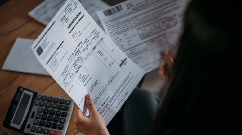 Woman holding utility bill