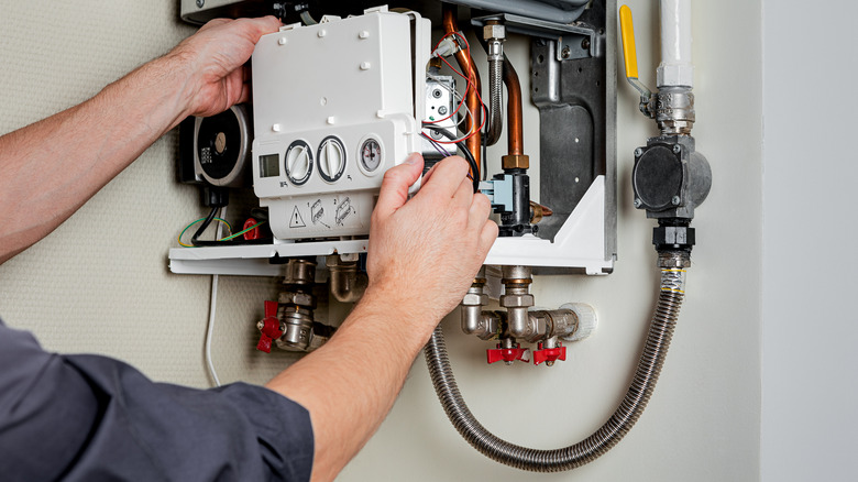 Closeup of person repairing gas boiler