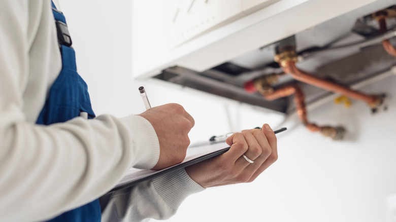 Heating professional writing on a clipboard