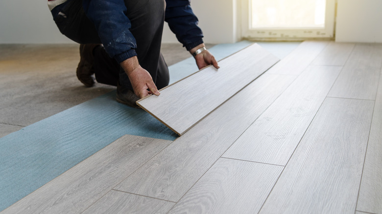 person installing flooring