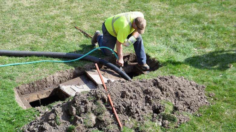 man working on septic maintenance