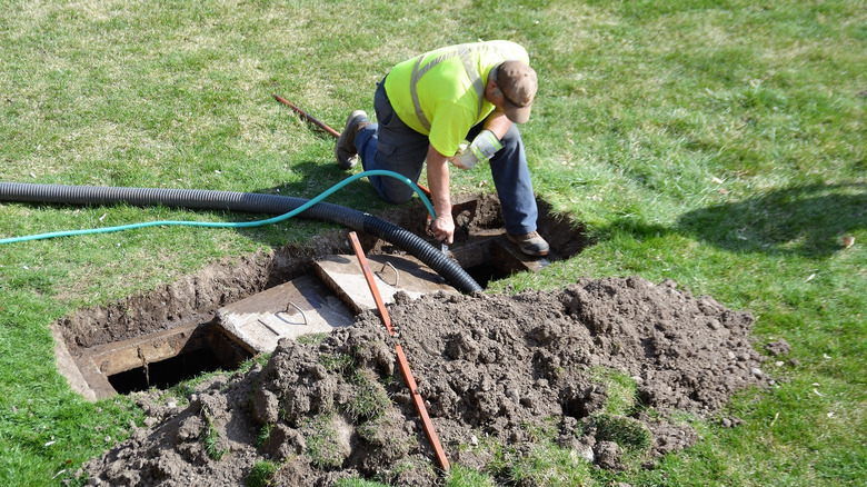 A man pumping out septic system