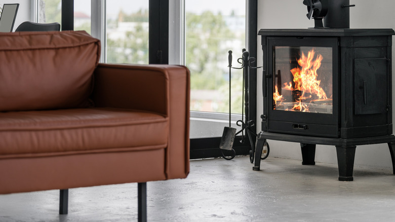 Leather sofa by fireplace