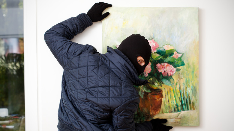 Robber with mask stealing art