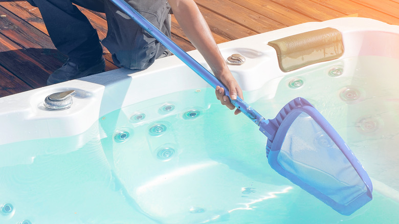 worker cleaning jacuzzi