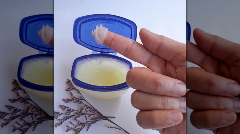 hand holding petroleum jelly