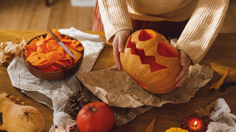 woman carving pumpkins