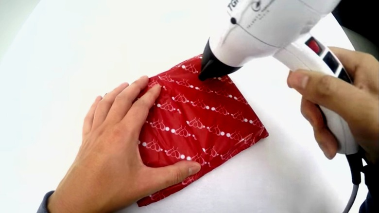 person wrapping gift in CoolWraps