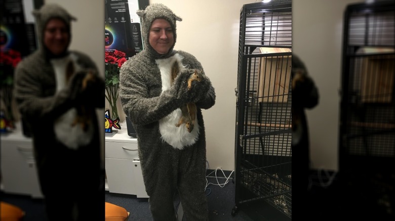 Man in costume holding squirrel