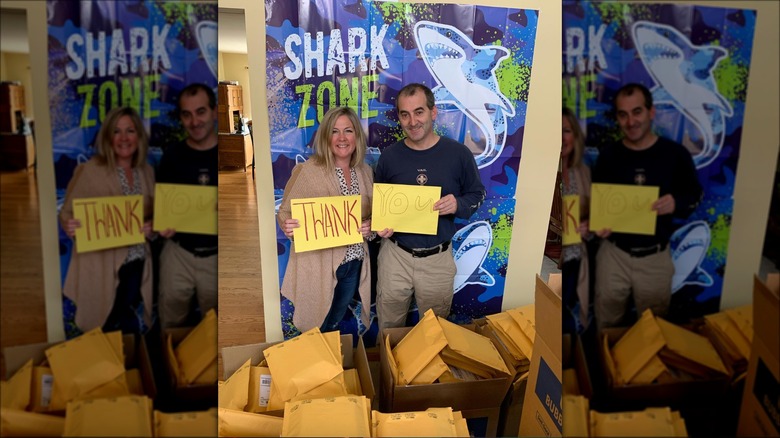 watne couple with thank you signs