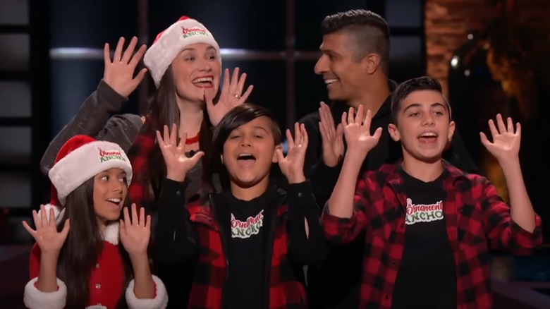 The Naqvi family raising hands